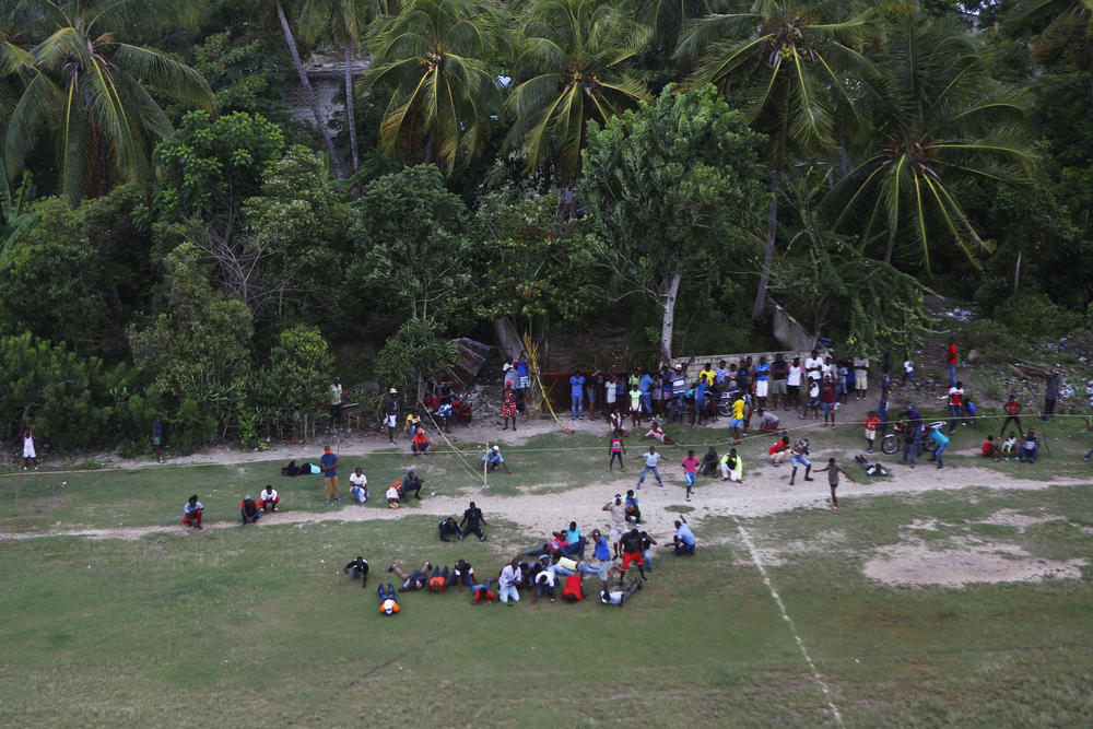An aerial view of families waiting to receive humanitarian aid delivered by a U.S. Army helicopter, in the town of Anse-a-Veau on Wednesday.