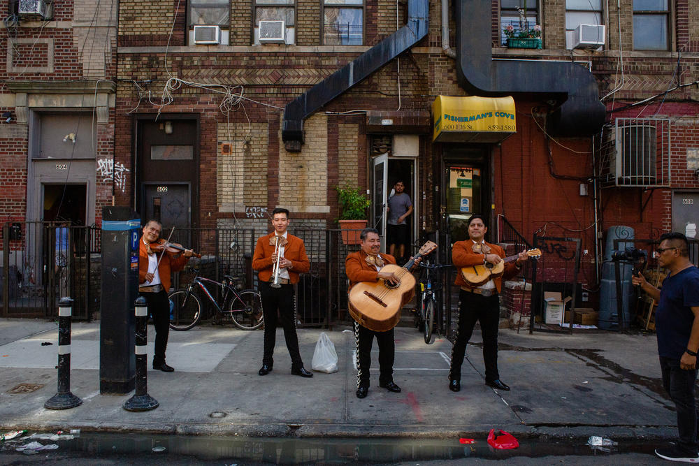 The Mariachi Aguila y Plata de Aguileo Ramos band plays outside of Antonio Salazar's home.