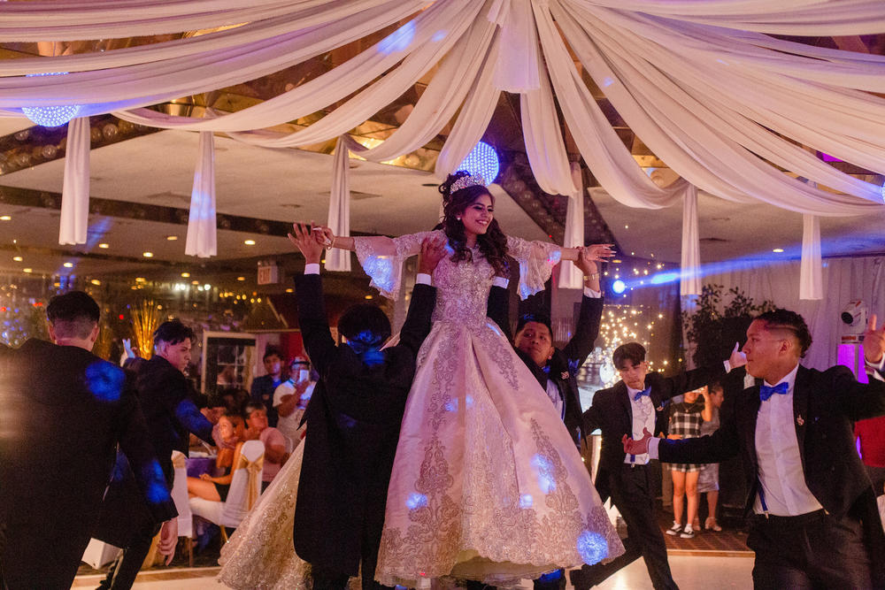 Citlaly Olvera Salazar is lifted by her court during a dance.