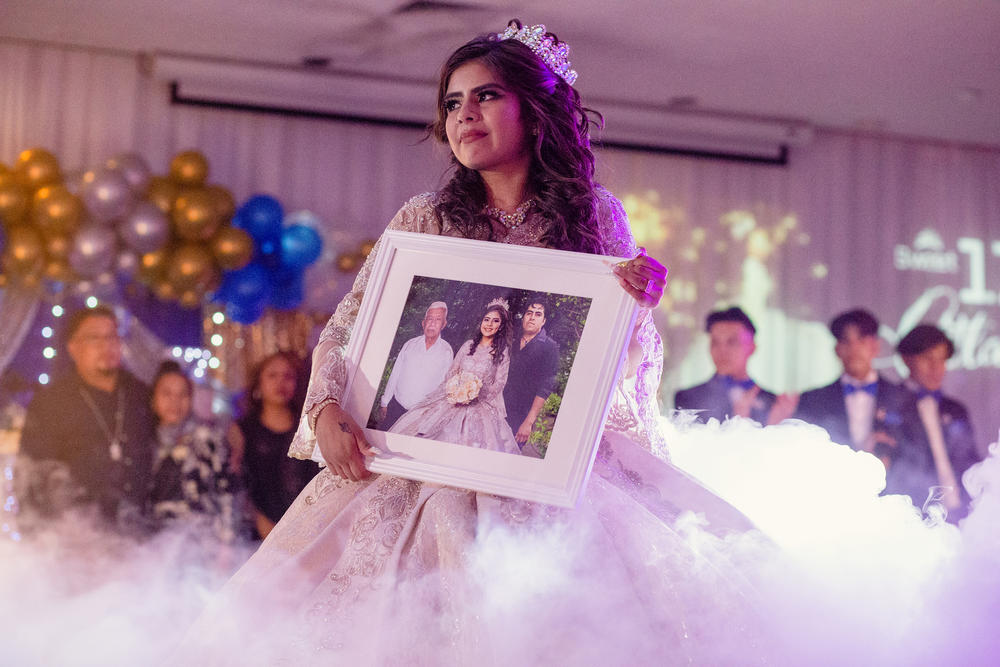 Citlaly Olvera Salazar dances with an altered image of her grandfather, Antonio Salazar, herself, and her father, Cesar Olvera, in their absence.