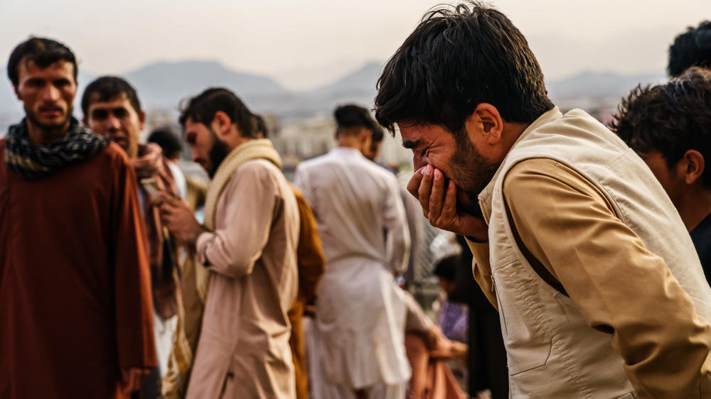 A man weeps during a mass funeral for members of a family was killed in a U.S. drone strike, in Kabul, Afghanistan, on Monday.