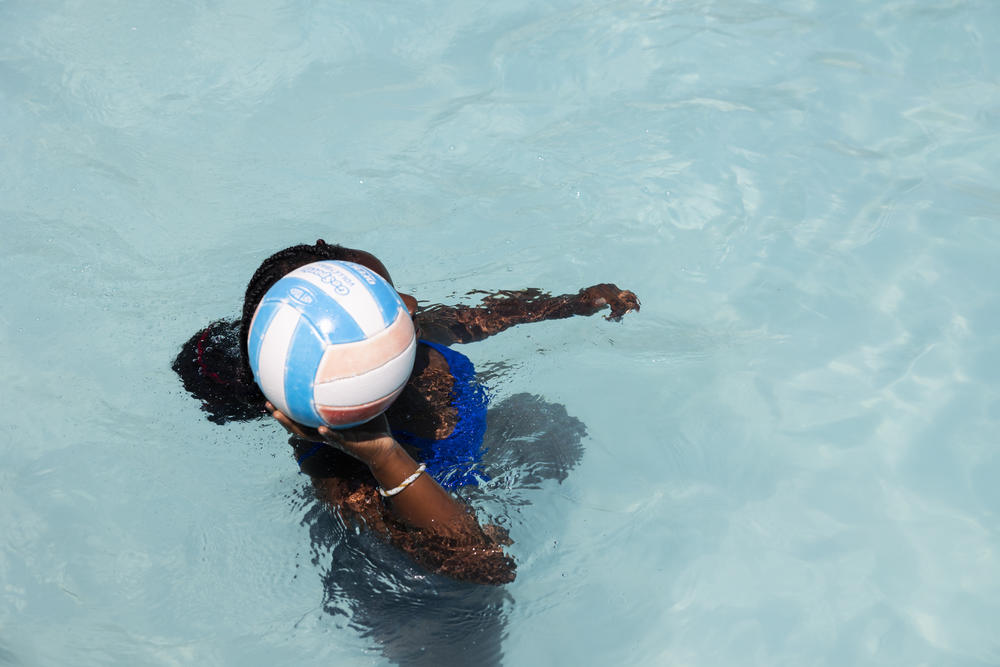 Ruby plays volleyball in the pool.