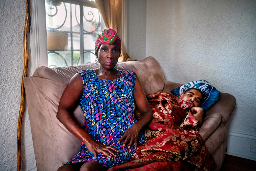 Grace Hollins and her son, Carl Hollins, who has cerebral palsy, at their home in New Orleans. Carl increasingly suffered in the severe heat in their apartment when electricity was out the week after Hurricane Ida.