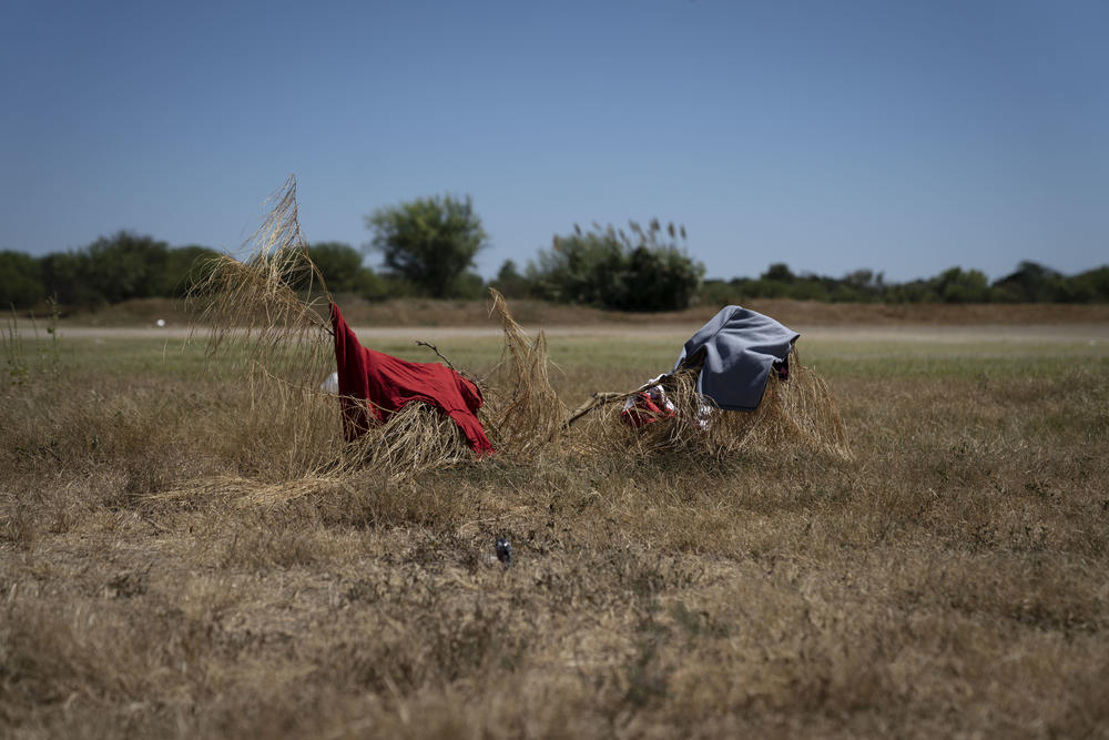 Clothes lay on branches in a makeshift migrant camp in Braulio Fernandez Ecological Park in Ciudad Acuña, Mexico.