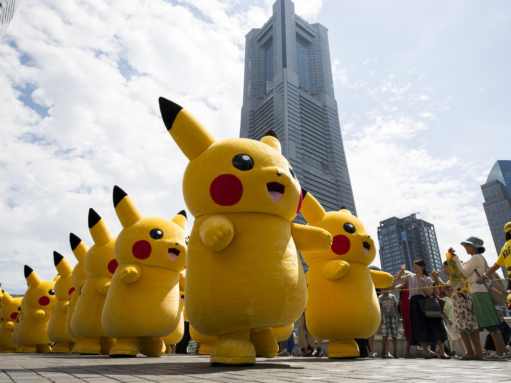 Performers dressed as Pikachu, a character from Pokemon series, march during the Pikachu Outbreak event hosted by The Pokemon Co. on August 9, 2017 in Yokohama, Kanagawa, Japan.
