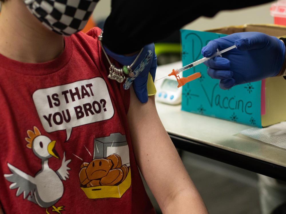 An older child gets vaccinated in Michigan. Pfizer and BioNTech say they will submit a formal request for emergency use authorization of the vaccine in children as young as 5 in the coming weeks.