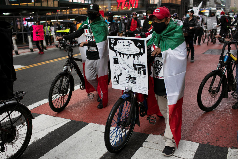 Food delivery riders take part in a street protest ride organized by the group 