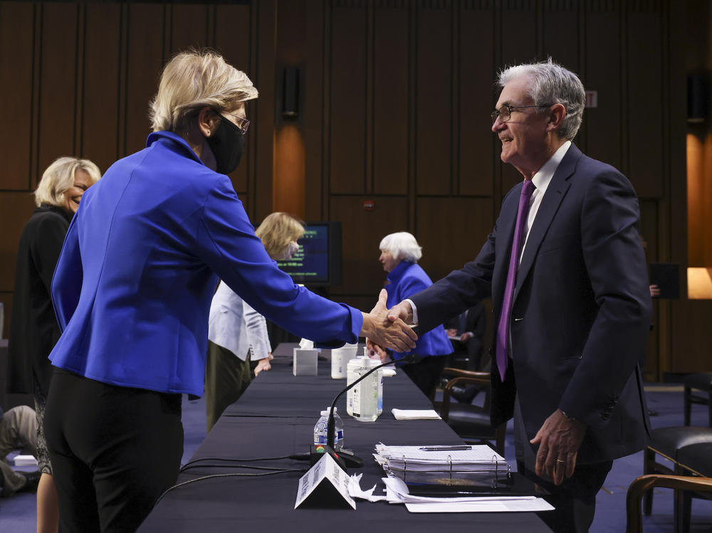 Sen. Elizabeth Warren, D-Mass., greets Powell before a Senate Banking, Housing and Urban Affairs Committee hearing on Sept. 28. Warren has been a strong critic of Powell, saying he has not been tough enough on banks.