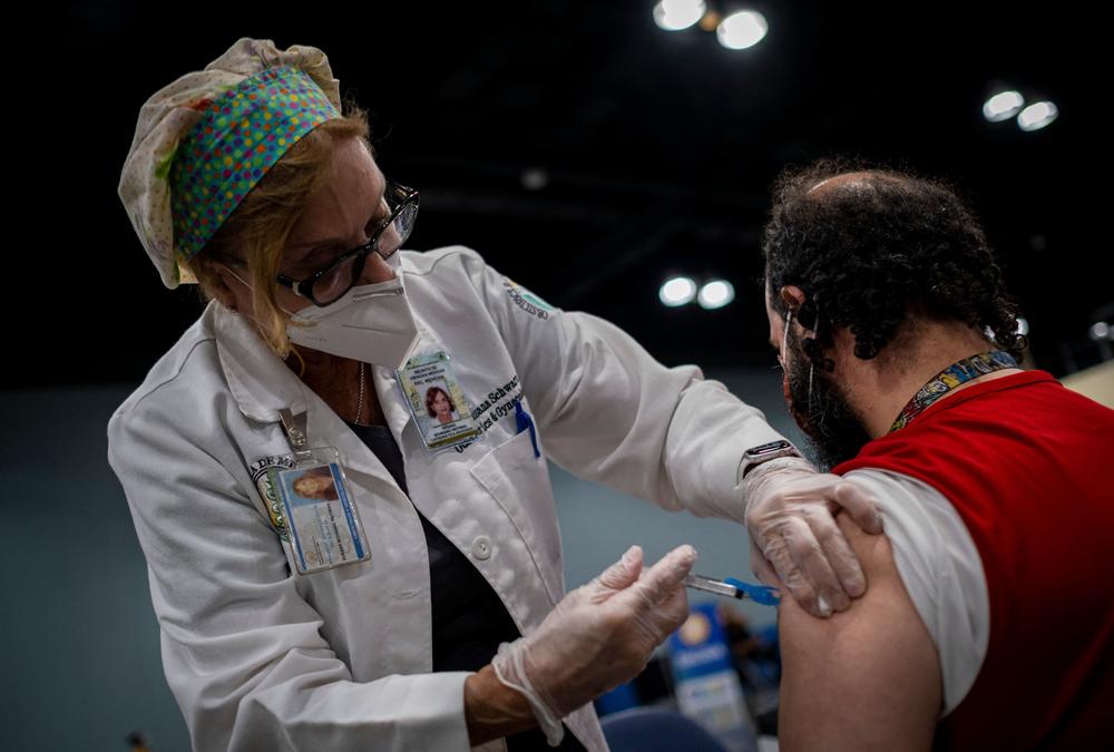 Dr. Susana Schwarz inoculates a man at the Puerto Rico Convention Center in San Juan during a mass COVID-19 vaccination event in March.