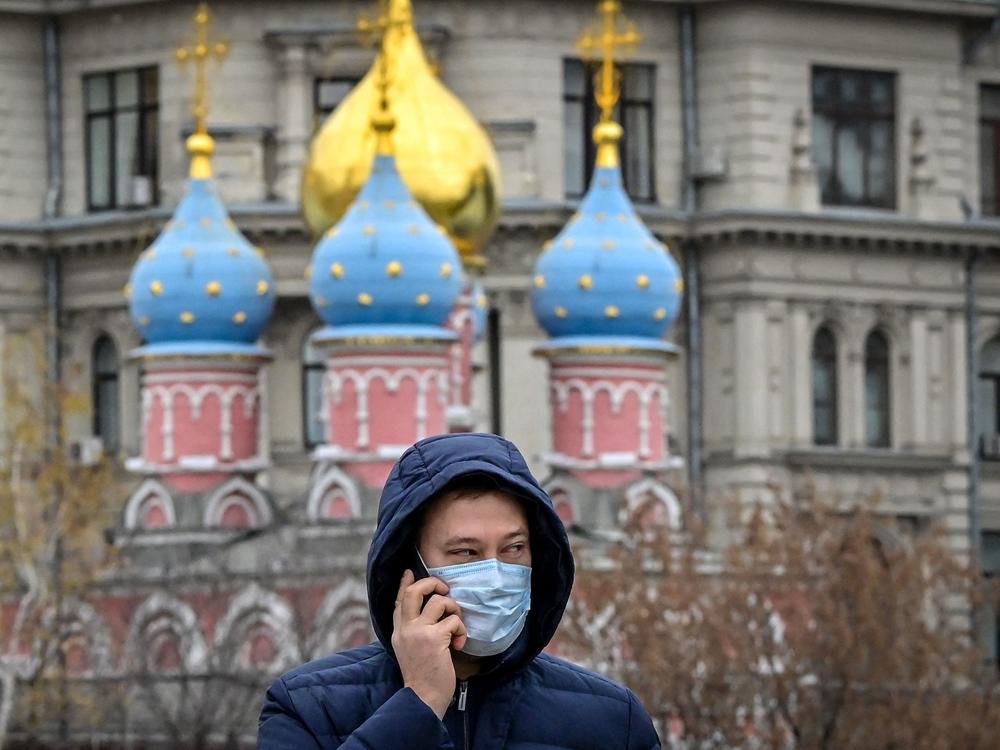 A man wearing a face mask speaks on his phone in central Moscow on Wednesday.