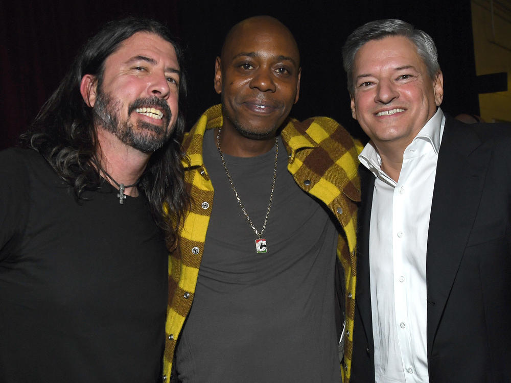 Foo Fighters frontman and inductee Dave Grohl joins comic Dave Chappelle and Netflix co-CEO Ted Sarandos backstage during the Rock & Roll Hall Of Fame Induction Ceremony in Cleveland, Ohio.