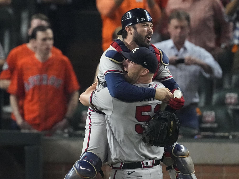 Atlanta Braves relief pitcher Will Smith and catcher Travis d'Arnaud celebrate after winning baseball's World Series in Game 6 against the Houston Astros Tuesday, in Houston. The Braves won 7-0.