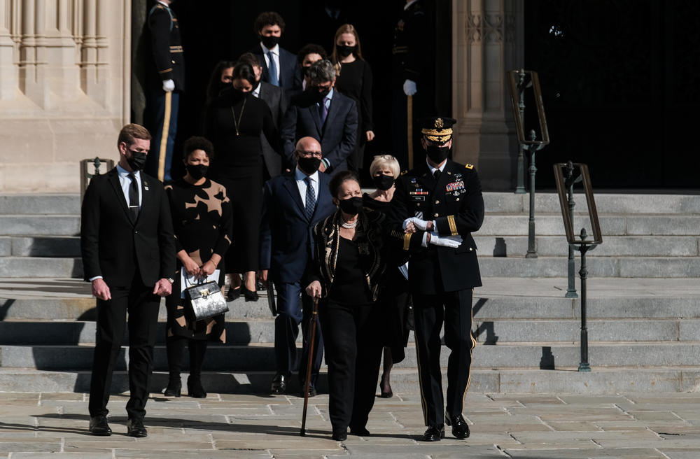 U.S Army Major General Allan M. Pepin, the Commanding General of Joint Task Forces escorts Gen. Colin Powell's widow Alma after the service.