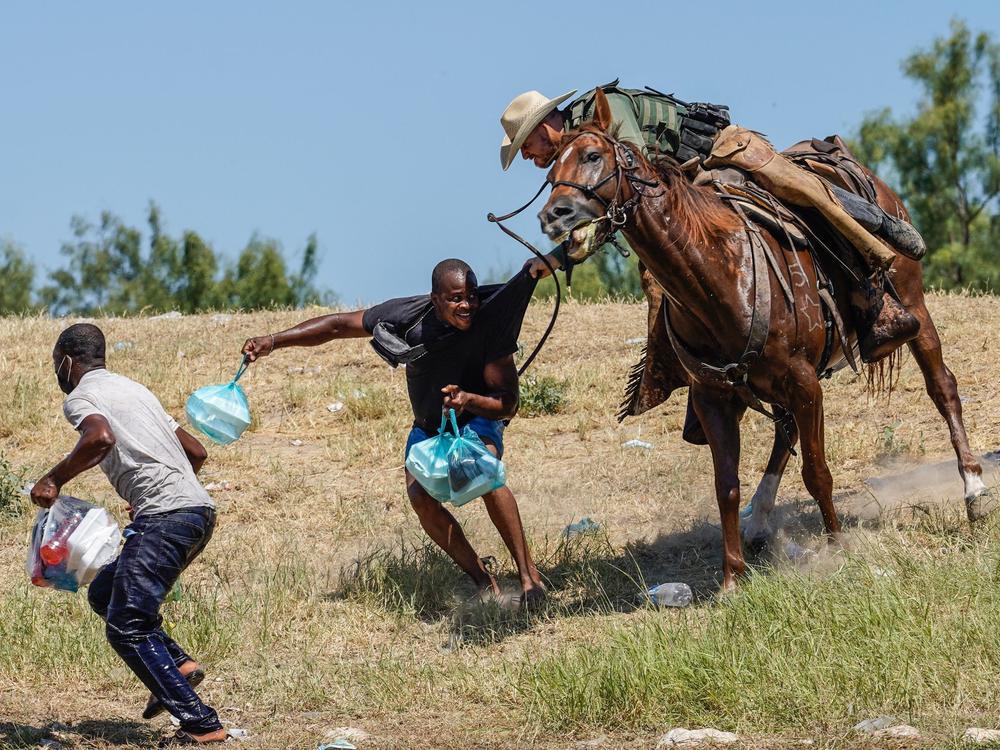 A United States Border Patrol agent on horseback tries to stop a Haitian migrant from entering an encampment on the banks of the Rio Grande near the Acuna Del Rio International Bridge in Del Rio, Texas on Sept. 19, 2021.
