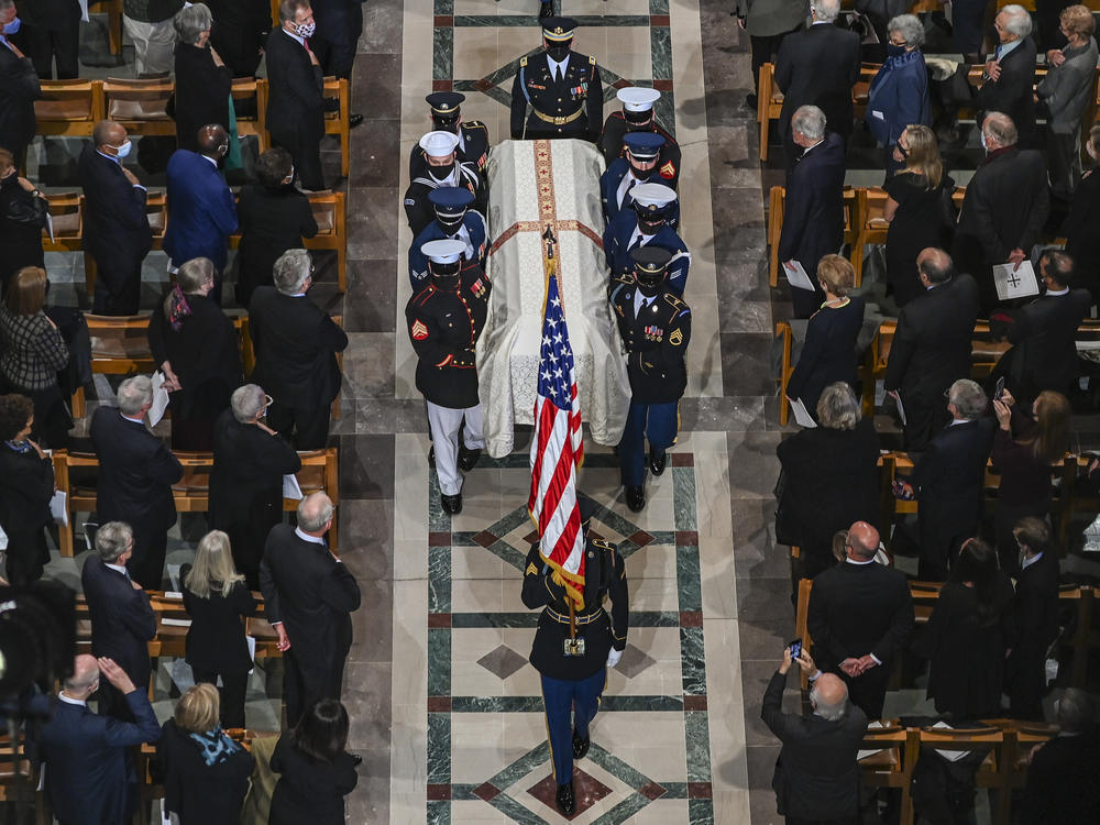Members of the Honor Guard carry the casket of former Secretary of State Colin Powell at National Cathedral in Washington, D.C.