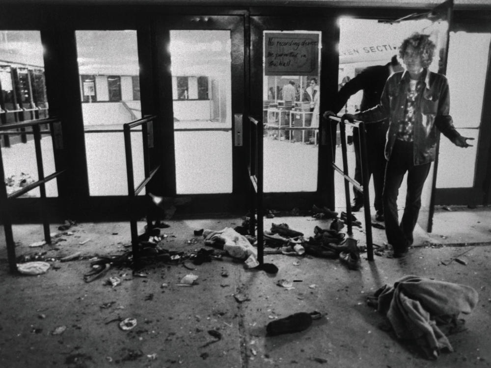 Debris litters the ground in front of the doors where people were trampled as they attempted to enter Cincinnati's Riverfront Coliseum for a Dec. 3, 1979 concert by The Who.