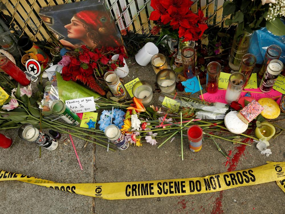 Candles, flowers and notes honor people who lost their lives in the Ghost Ship fire in Oakland, Calif., in December 2016.