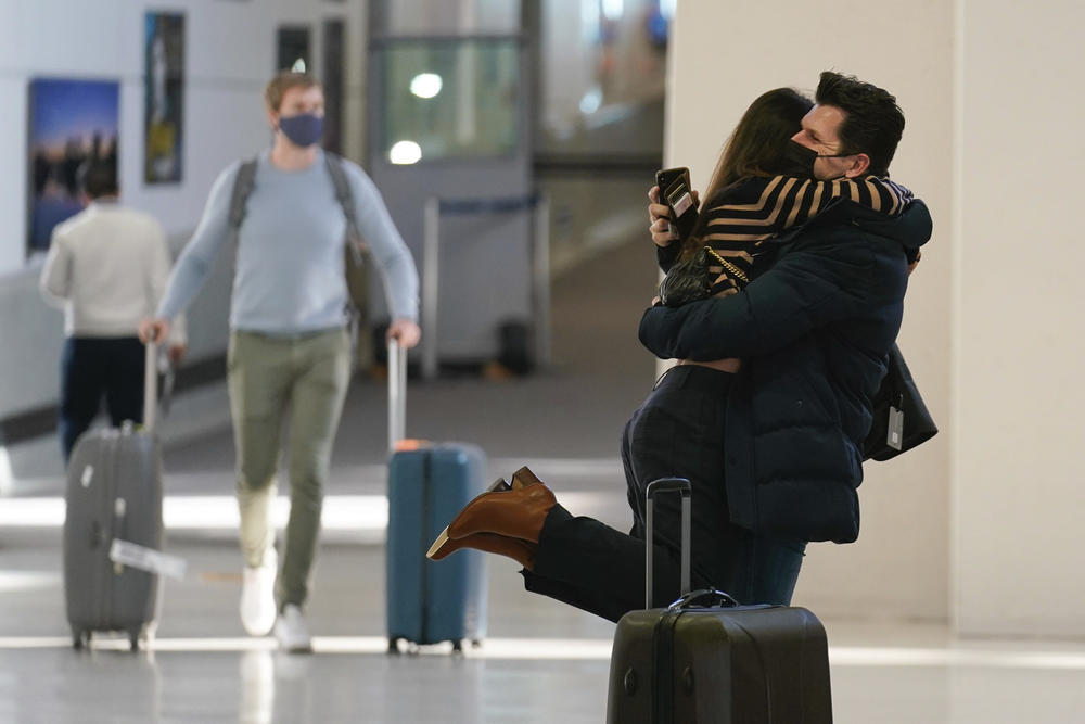 Natalia Abrahao is lifted up by her fiancé Mark Ogertsehnig as they greet one another at Newark Liberty International Airport in Newark, N.J.
