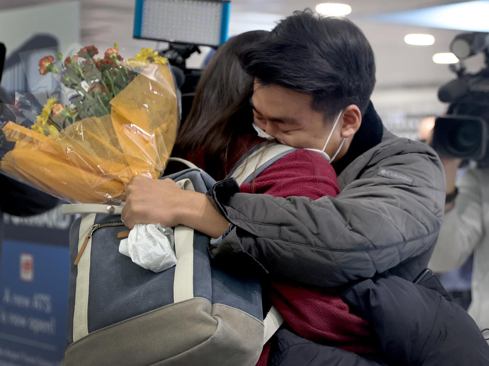 Yerin Hong gets a hug from her boyfriend Soomin Kim after she arrived on a flight from Germany at the international terminal at O'Hare International Airport in Chicago, Illinois.