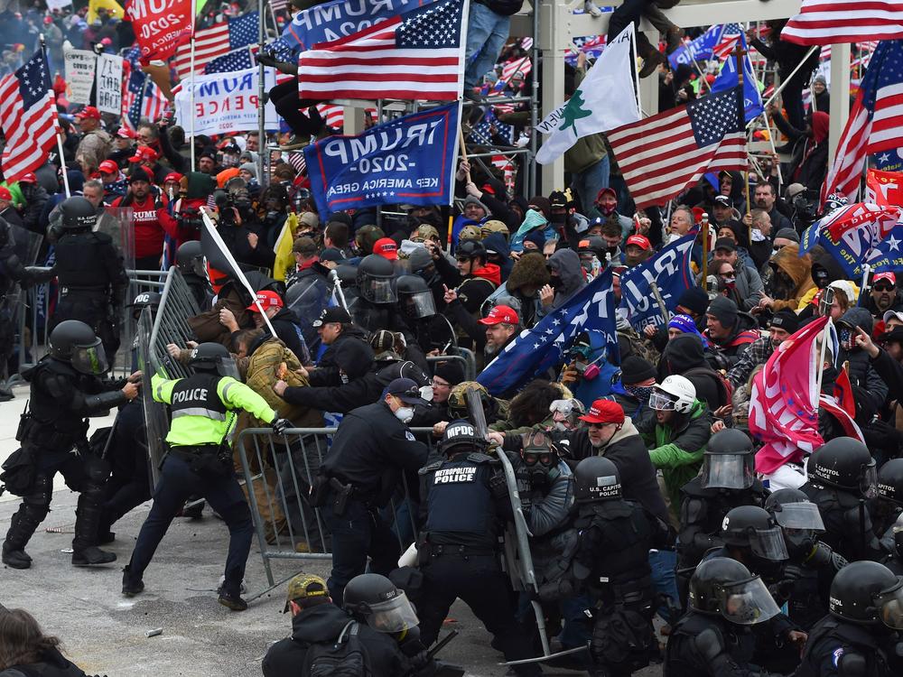 Trump supporters clash with police and security forces during the insurrection at the Capitol on Jan. 6.