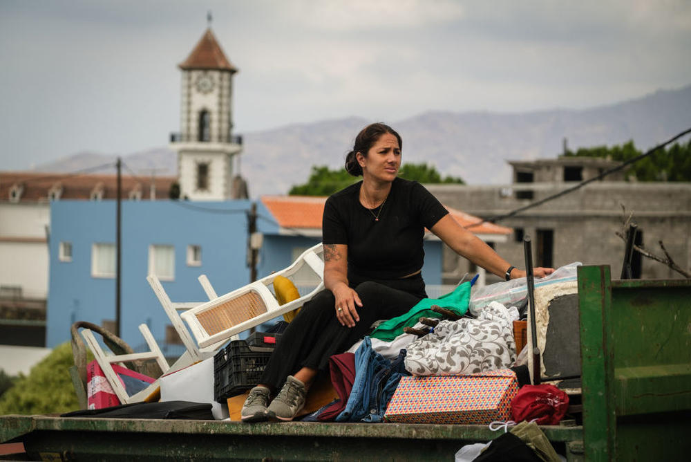 A woman is evacuated to safety with the belongings she could gather, as the Cumbre Vieja volcano on La Palma continues to erupt after two months. It's forced thousands from their homes.