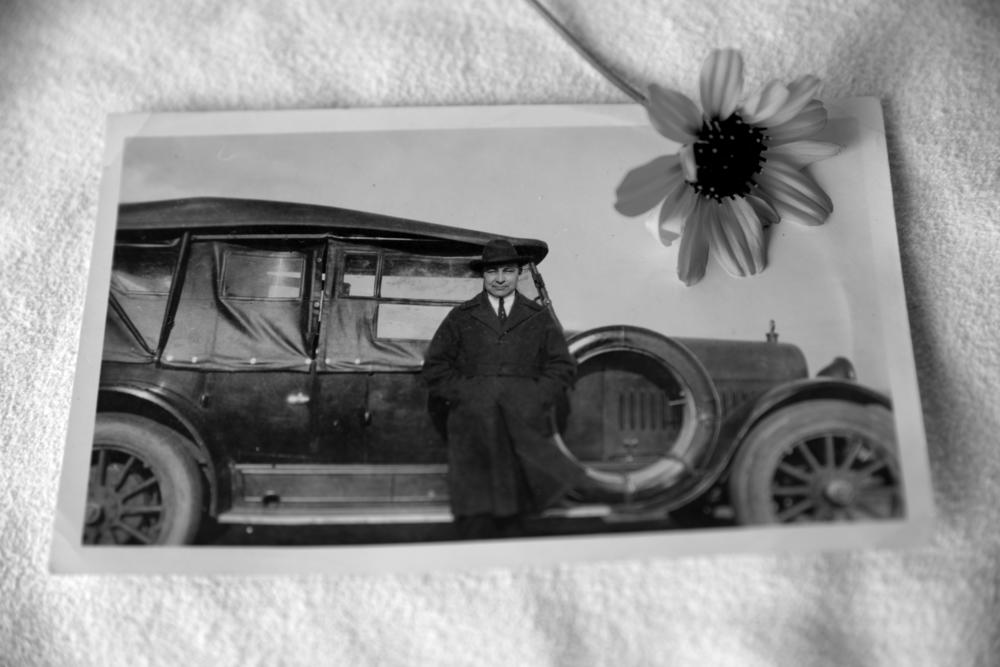 John B. McGillis stands in front of an early automobile, in an unknown location. His great granddaughter says McGillis truly embodied a duality of existence, as his knowledge of traditional customs and beliefs intersected with his ability to adapt to the rapid modernization of the times.