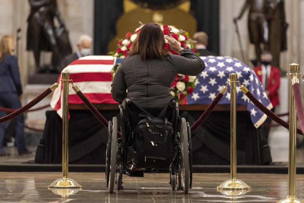 Democratic Sen. of Illinois Tammy Duckworth pays her respects in front of former Sen. Bob Dole, in the rotunda of the U.S. Capitol.