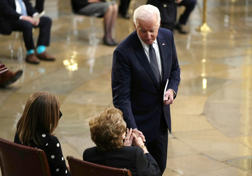 President Joe Biden greets former Sen. Elizabeth Dole as they gather to pay their respects to former Sen. Bob Dole as he lies in state at the Rotunda of the U.S. Capitol on Dec. 9, 2021 in Washington, D.C.