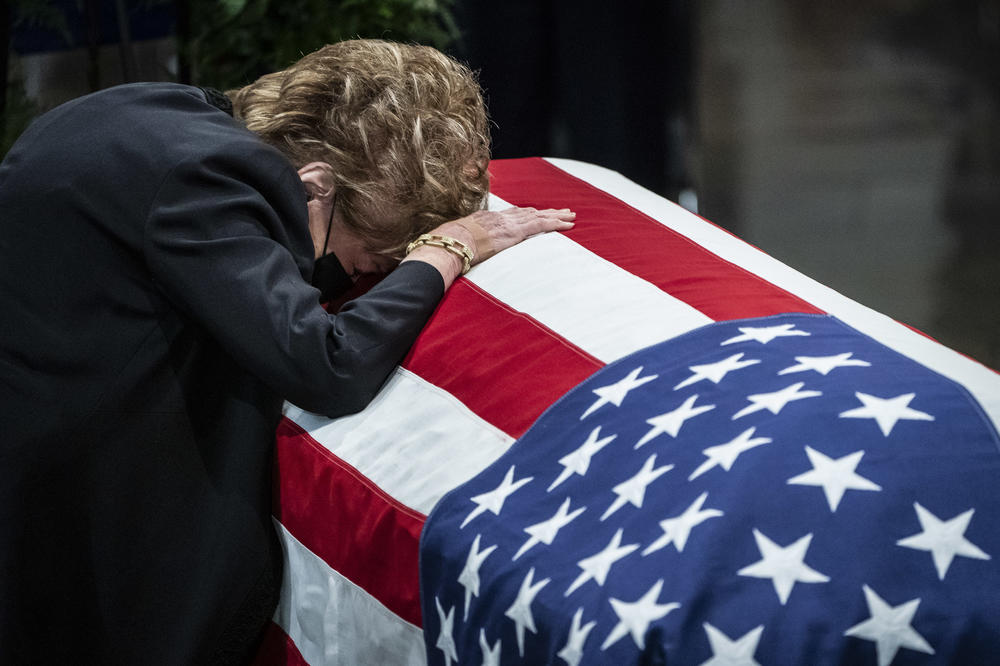 Former Sen. Elizabeth Dole rests her head on the casket of her husband and former Sen. Bob Dole (R-KS) in the Rotunda of the U.S. Capitol building, where lays in state, on Dec. 9, 2021 in Washington, D.C.