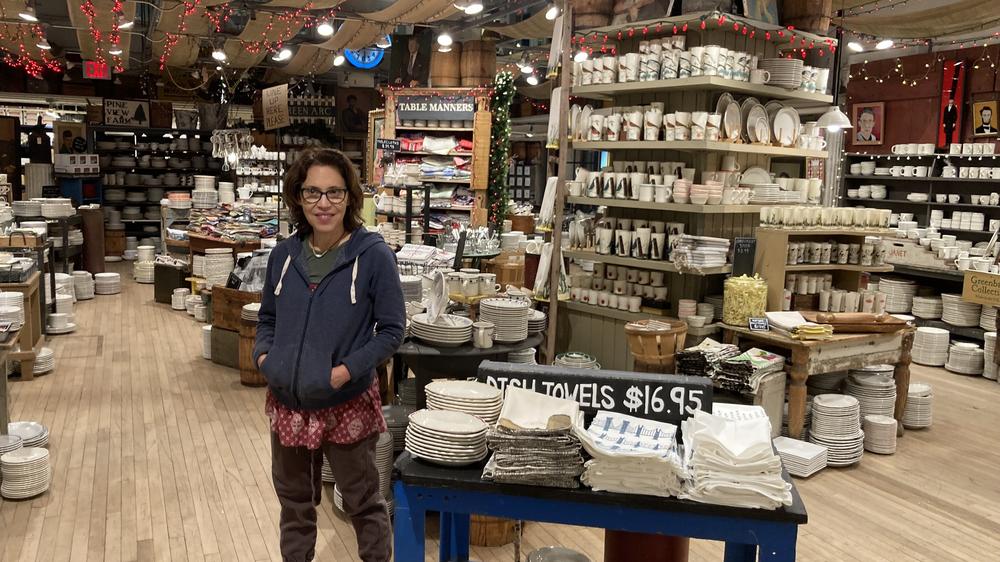 Julie Gaines, owner of New York home goods store Fish's Eddy, poses in front of her collection of cups and plates.
