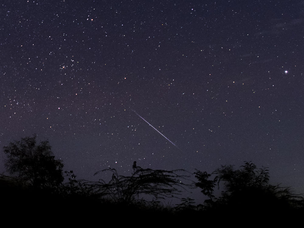 This photo taken late on Dec. 14, 2018, with a long time exposure shows a meteor streaking through the night sky over Myanmar during the Geminid meteor shower, seen from Wundwin township near the city of Mandalay.