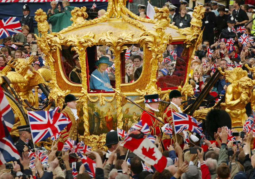 <strong>June 4, 2002:</strong> Queen Elizabeth II and Prince Philip ride in the Golden State Carriage at the head of a parade from Buckingham Palace to St. Paul's Cathedral to celebrate the Queen's Golden Jubilee along The Mall in London, England.