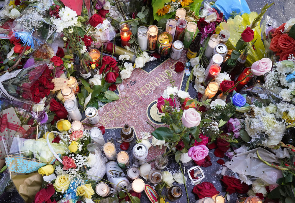 Flowers and candles surround the Hollywood Walk of Fame star of the late Mexican musician Vicente Fernández, Monday, in Los Angeles.