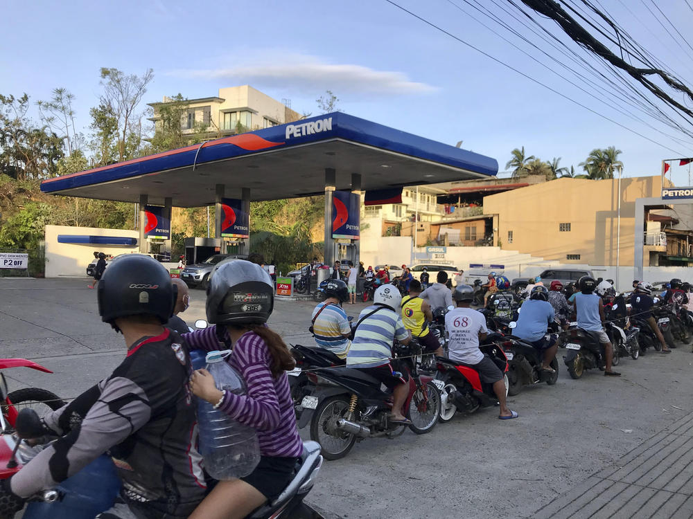 Residents line up for gasoline after Typhoon Rai damaged parts of Cebu city, central Philippines on Saturday, Dec. 18, 2021.