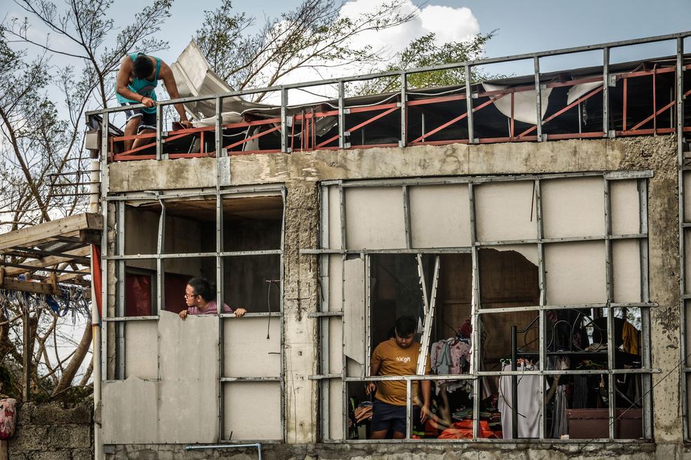 Residents inspect their destroyed house in Surigao City, Surigao del norte province, on December 19, 2021, days after super Typhoon Rai devastated the city.