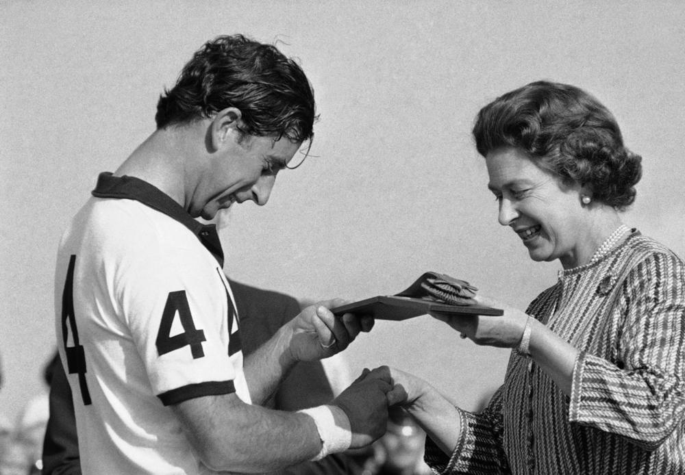 <strong>July 26, 1981:</strong> Queen Elizabeth II presents her son Prince Charles with a trophy after the Prince's team, England II, beat Spain 10-5 for the Silver Jubilee Polo Cup at the Guards Polo Club in Windsor, England.