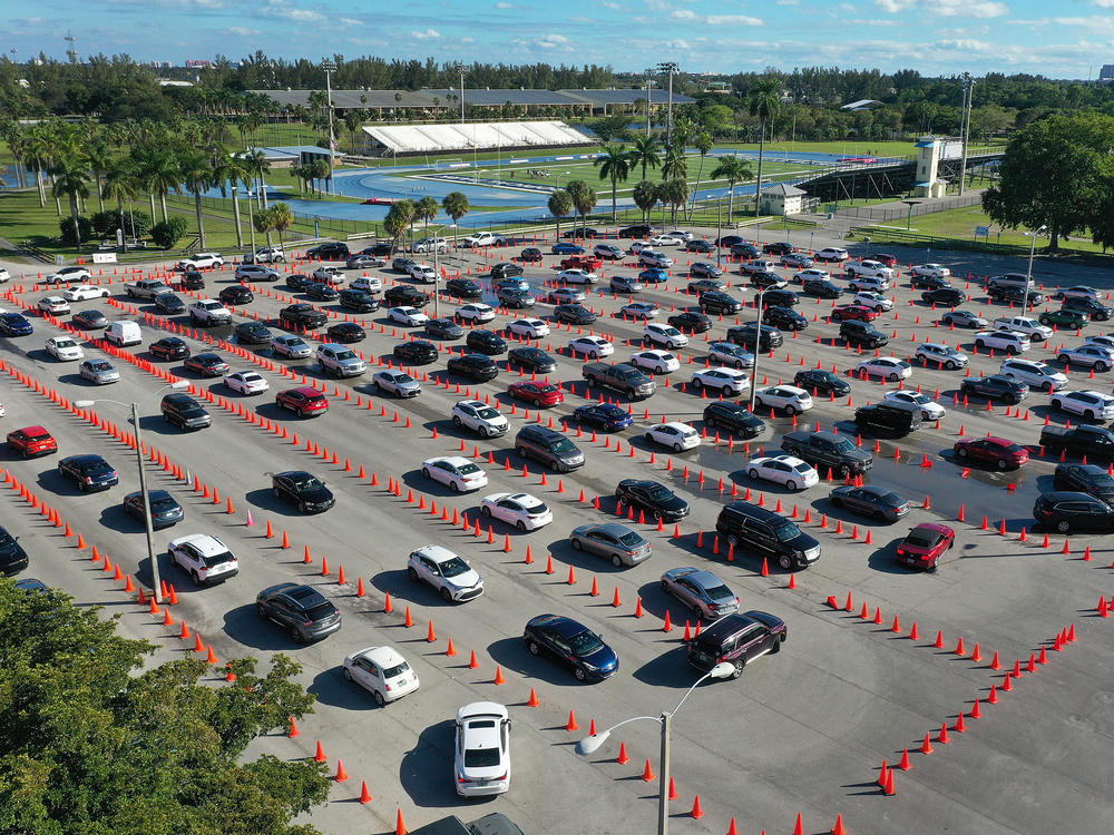 Cars line up at a drive-thru COVID-19 testing site at Miami's Tropical Park on Wednesday.