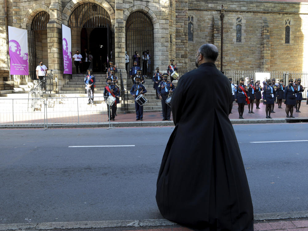A cleric awaits the arrival of the coffin carrying the body of Anglican Archbishop Emeritus Desmond Tutu at the St. George's Cathedral.