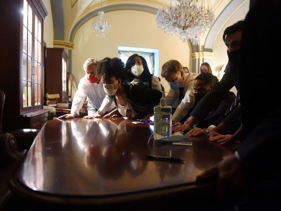 Congressional staffers barricade themselves after Trump supporters break into the Capitol on Jan. 6, 2021.