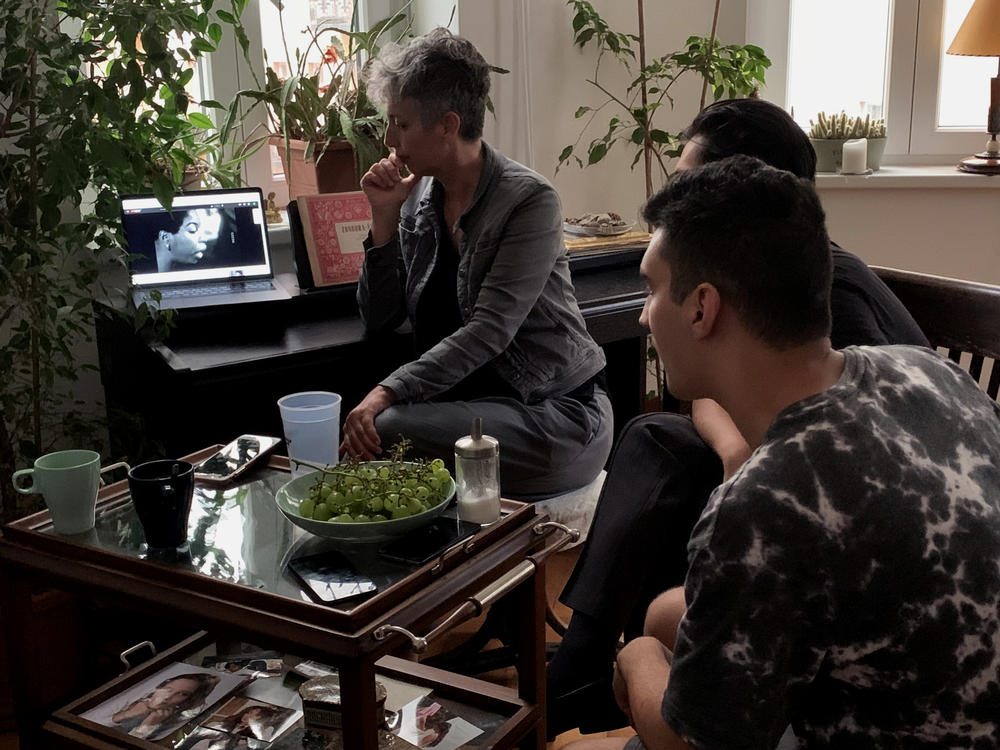 Kriszta Bodis, who runs the education nonprofit Van Helyed (You Belong) in Budapest, shows a Nina Simone video to the young Roma writers who are translating Amanda Gorman's new book of poetry, <em>Call Us What We Carry</em>.