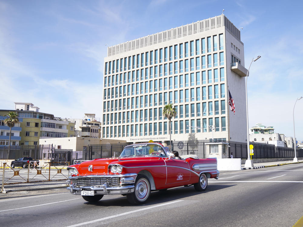 A car drives past the U.S. Embassy in Havana in 2019. Americans working at the embassy began reporting unexplained illnesses in 2016.