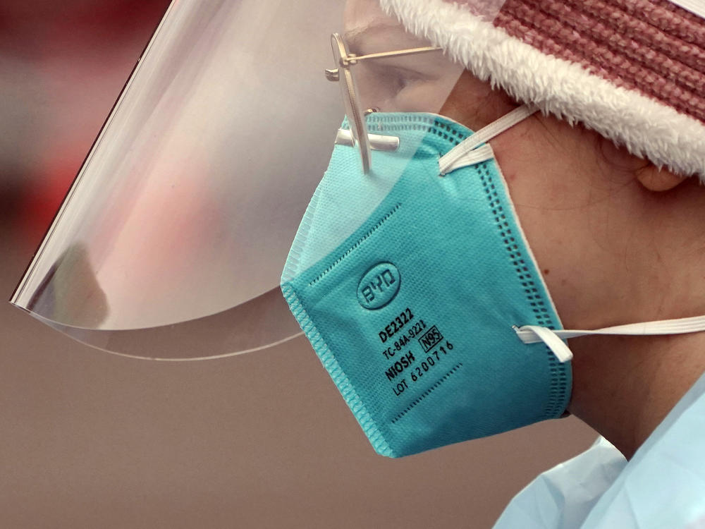 Linsey Jones, a medical assistant working at a drive-up coronavirus testing clinic, wears an N95 mask on Jan. 4 in Puyallup, Wash. The Biden administration will begin making 400 million N95 masks available for free to Americans starting this week.