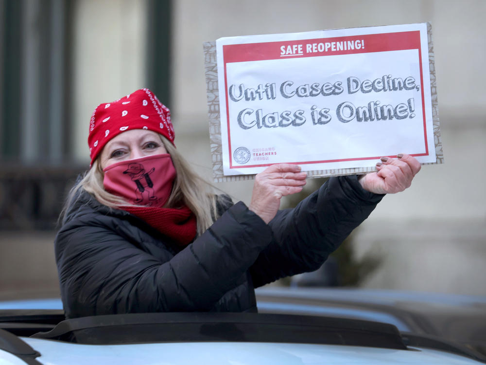 Members of the Chicago Teachers Union and their supporters participate in a car caravan around City Hall to protest against in-person learning in Chicago public schools on January 10, 2022 in Chicago, Illinois.
