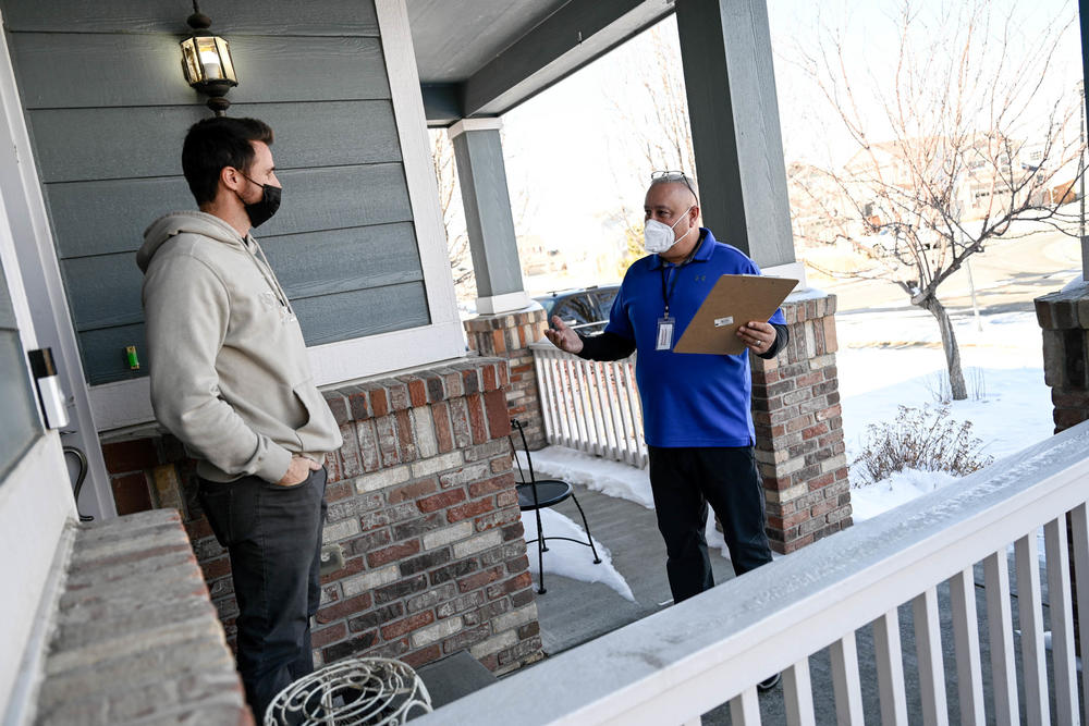 Chaz Tedesco, who serves on the Adams County Commission, asks for a petition signature from neighbor Ryan Goff as he canvasses on Jan. 29. Tedesco is running for Colorado's 8th Congressional District.