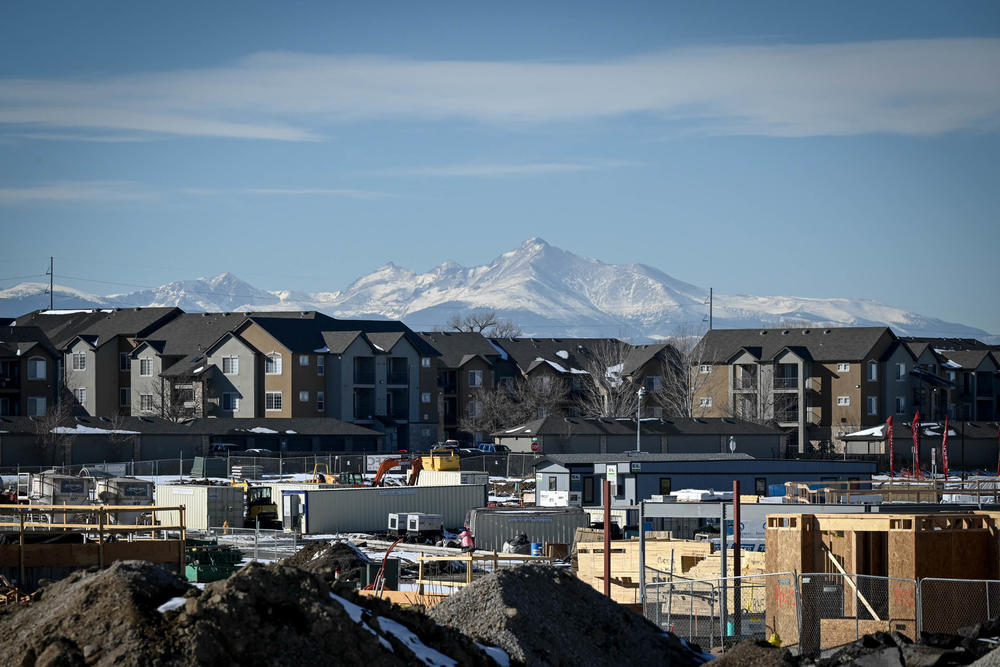 A development takes shape in January in Thornton, Colo., with the Rocky Mountains in the distance.