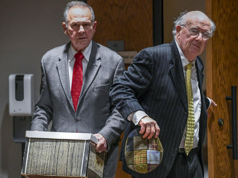 Former Alabama Chief Justice Roy Moore, left, and his attorney Julian McPhillips leave the courtroom in the Montgomery County Courthouse in Montgomery, Ala., on Jan. 24 following jury selection.