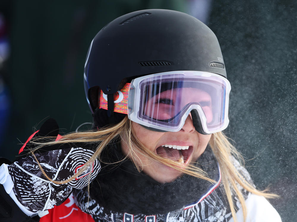 U.S. snowboarder Chloe Kim reacts after her first stellar run of the women's snowboard halfpipe final at the 2022 Winter Olympics.