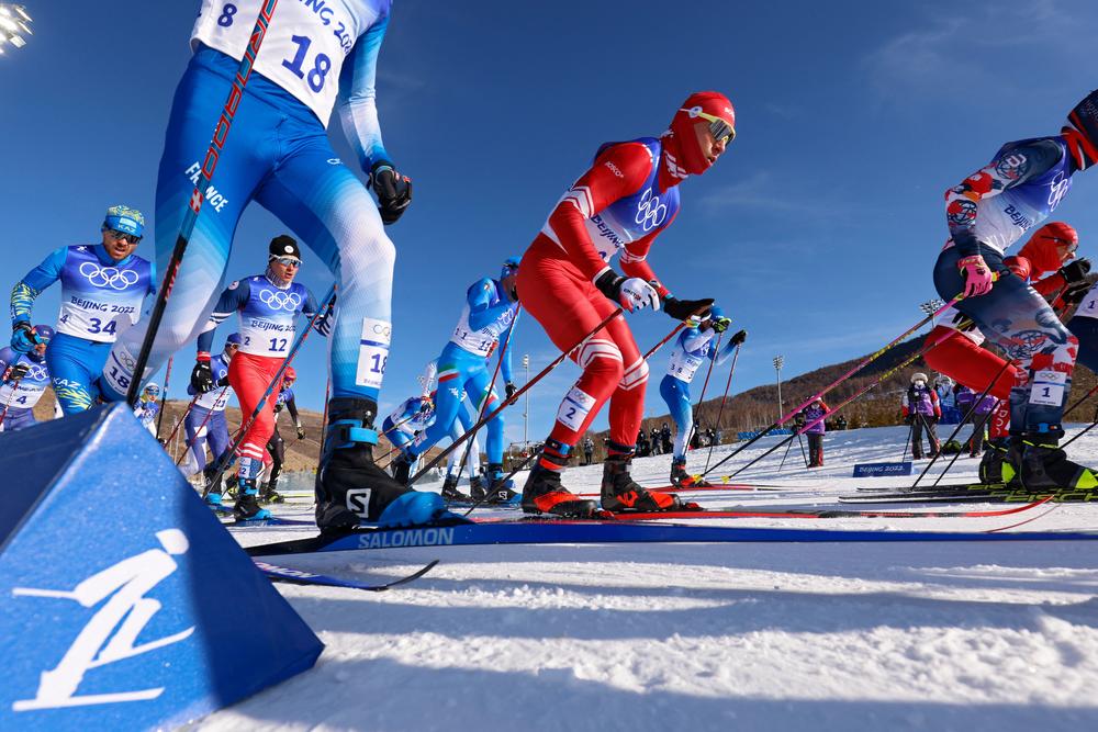 Russia's Alexander Bolshunov (C) competes in the men's skiathlon 2x15km event during the Beijing 2022 Winter Olympic Games on February 6, 2022, at the Zhangjiakou National Cross-Country Skiing Centre.