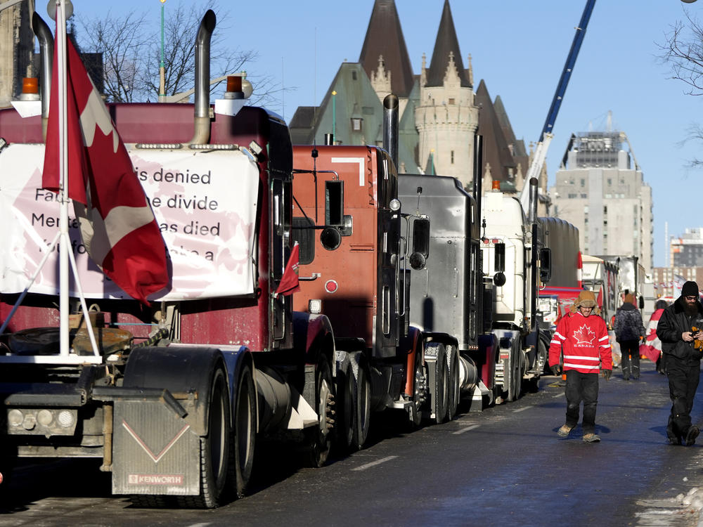 A person wears a Team Canada hockey jersey after city officials negotiated to move some trucks towards Parliament and away from downtown residences on the 18th day of a protest against COVID-19 measures that has grown into a broader antigovernment protest in Ottawa on Monday.