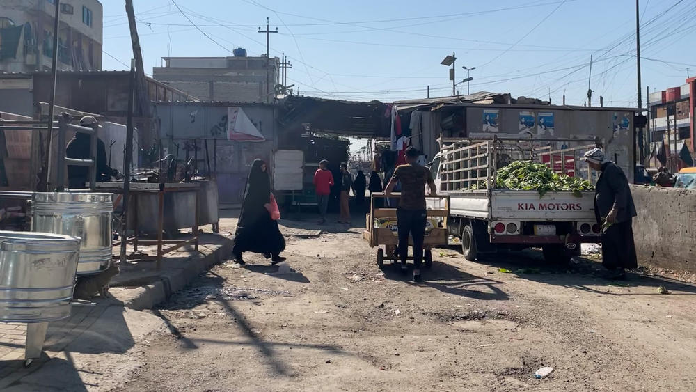 The entry to Al Wihelaat market in the working class Sadr City neighborhood of Baghdad, Iraq. Most vendors inside the market have stopped wearing masks, with many saying the pandemic is behind them.